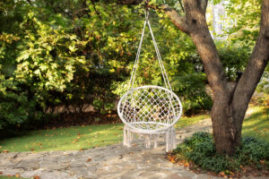 comfortable,hanging,wicker,white,chair,in,summer,garden.,cozy,hygge