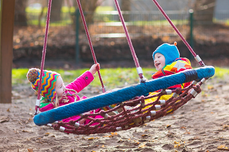 little,boy,and,girl,on,a,playground.,child,playing,outdoors