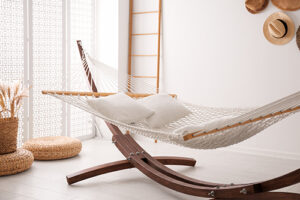 comfortable,hammock,with,pillows,in,stylish,room.,interior,design